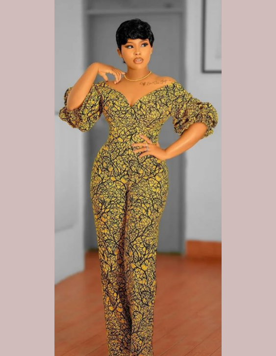 showcasing a woman wearing an ankara jumpsuit style design lady on ankara jumpsuit style#ankarastyles #ankaradress
